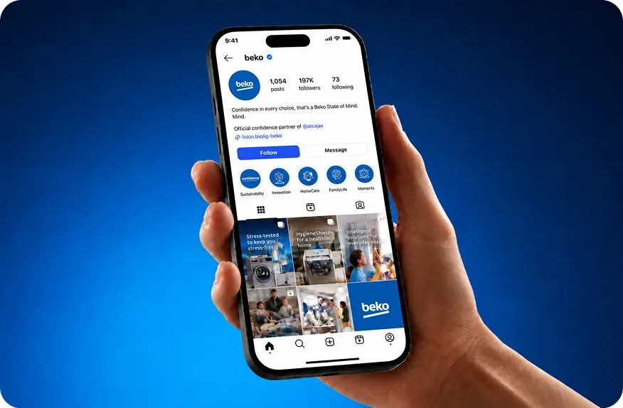 A hand holding up a mobile phone displaying the Beko Instagram page