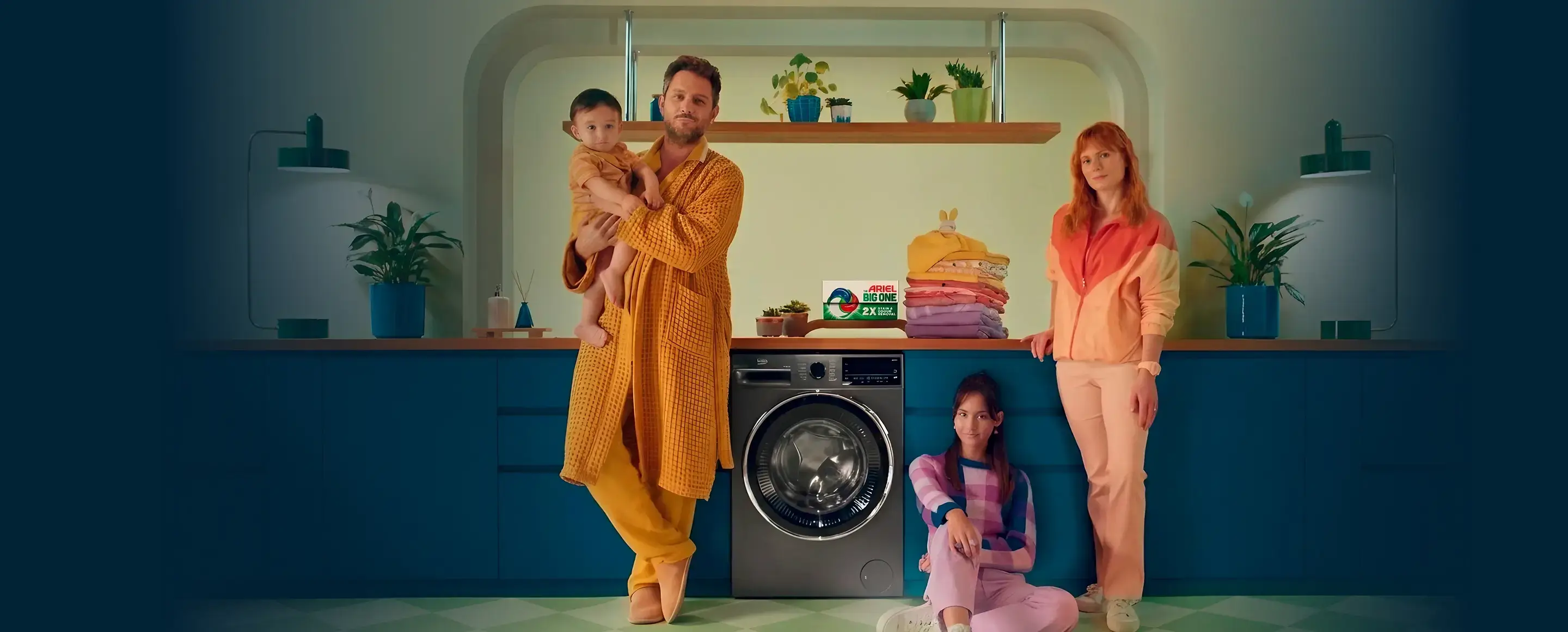 A photo of a family by a Beko washing machine