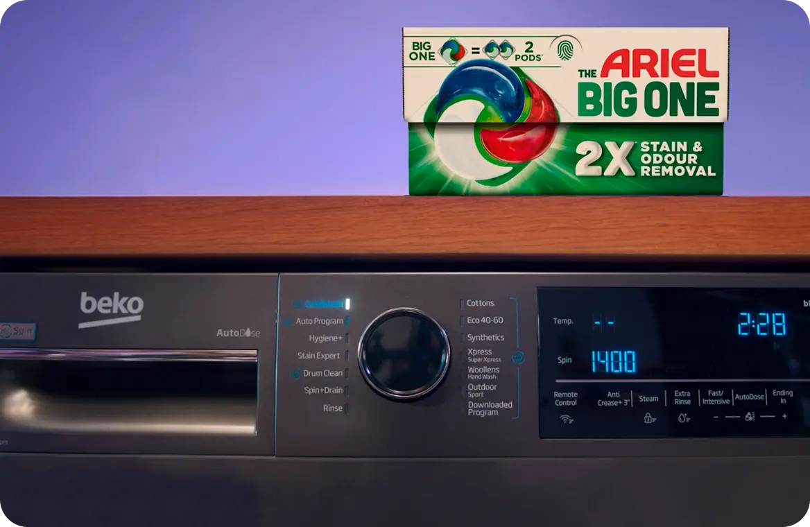 A box of Arial The Big One on top of a grey Beko washing machine