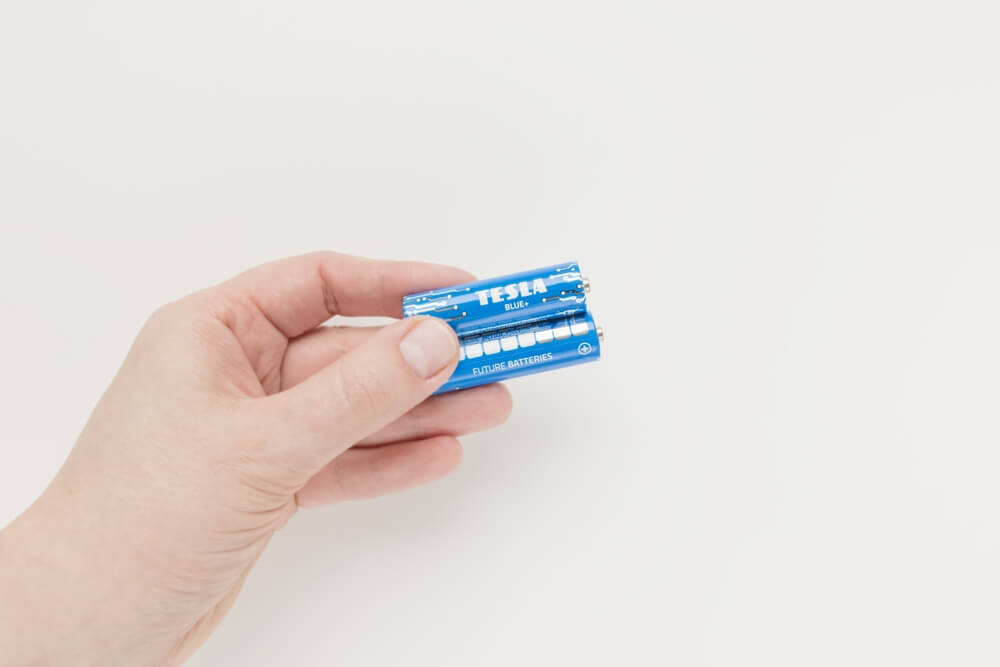 2 batteries being held